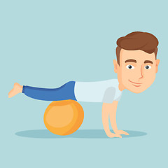 Image showing Young man exercising with fitball.