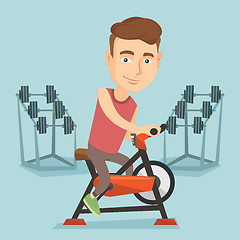 Image showing Young man riding stationary bicycle.