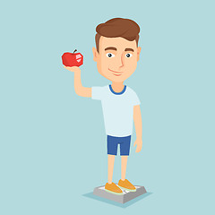 Image showing Man standing on scale and holding apple in hand.