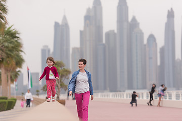 Image showing mother and cute little girl on the promenade