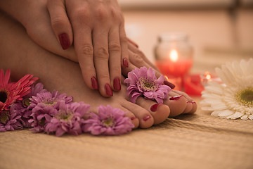 Image showing female feet and hands at spa salon