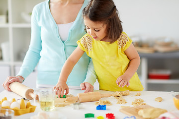 Image showing happy mother and daughter making cookies at home