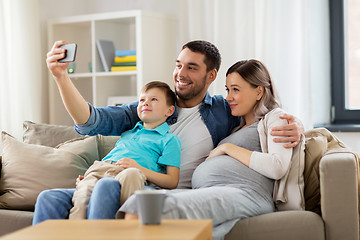 Image showing happy family taking selfie with smartphone at home