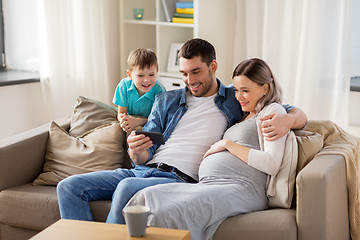 Image showing happy family with smartphone at home