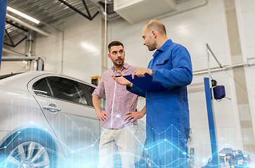 Image showing auto mechanic with clipboard and man at car shop