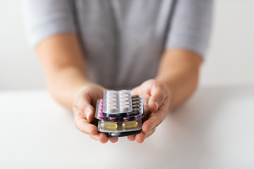 Image showing woman hands holding packs of pills