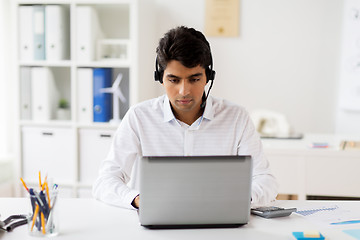 Image showing businessman with headset and laptop at office