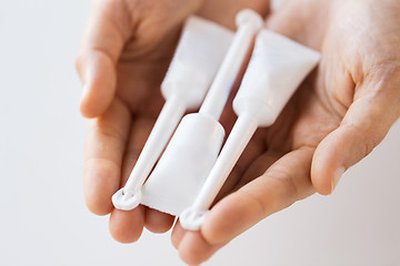 Image showing hand holding tubes of micro enema