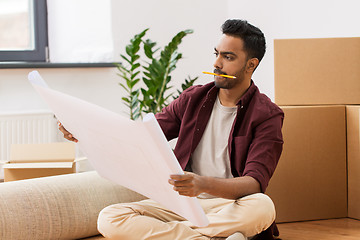 Image showing man with blueprint and boxes moving to new home