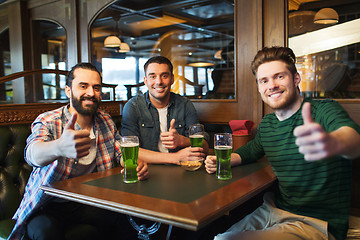 Image showing male friends drinking green beer at bar or pub