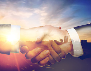 Image showing businessman and businesswoman shaking hands