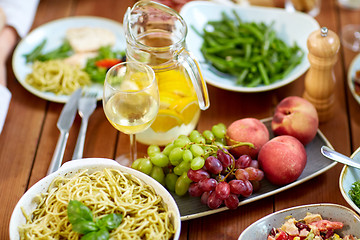 Image showing fruits, salads and pasta on wooden table