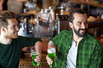 Image showing male friends drinking green beer at bar or pub