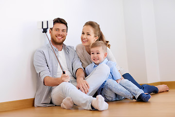 Image showing family taking selfie by smartphone at new home