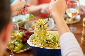 Image showing pasta with basil in bowl and other food on table