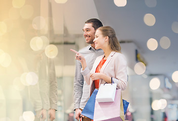 Image showing happy young couple with shopping bags in mall