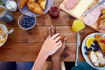 Image showing couple hands on table full of food