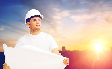 Image showing male builder in white hard hat with blueprint