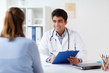 Image showing doctor with clipboard and patient at hospital