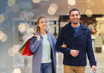 Image showing happy young couple with shopping bags in mall