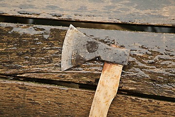 Image showing Axe on wet planks