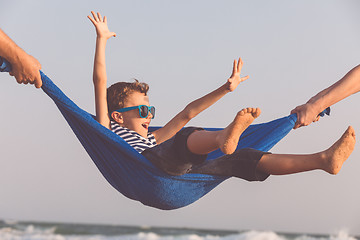 Image showing Happy little boy relaxing on the beach at the day time