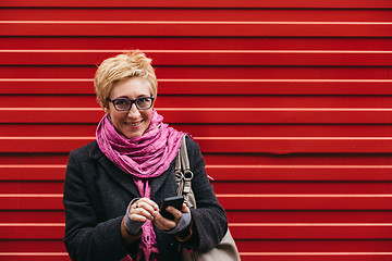 Image showing Smiling adult woman with smartphone