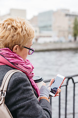 Image showing Woman using smartphone at river