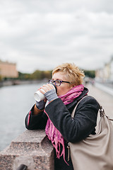 Image showing Woman drinking coffee on waterfront