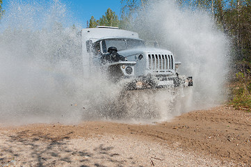 Image showing truck passes through a puddle