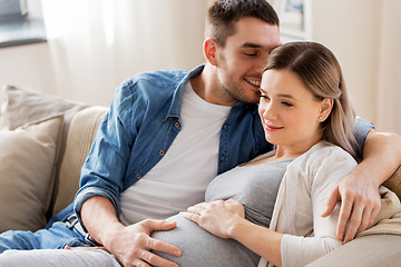 Image showing man hugging pregnant woman at home