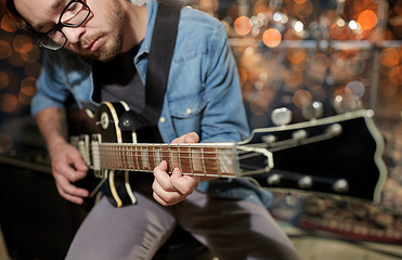 Image showing musician playing guitar at studio or music concert