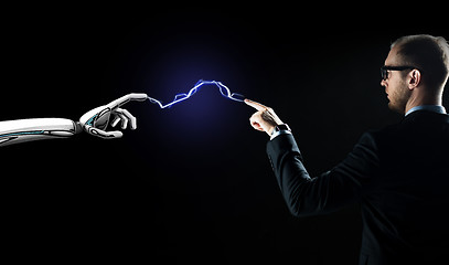 Image showing robot and businessman connected by lightning