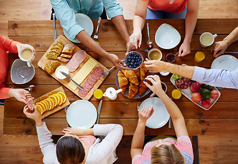 Image showing group of people having breakfast at table