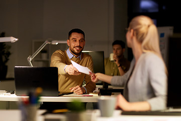 Image showing coworkers with papers working late at office