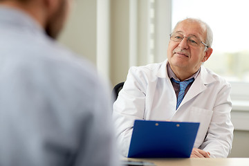 Image showing senior doctor talking to male patient at hospital