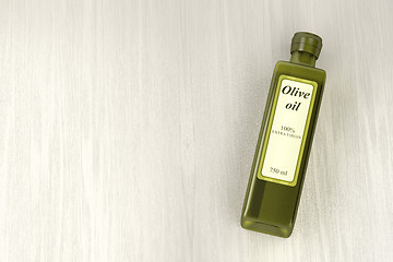 Image showing Olive oil bottle on wood background