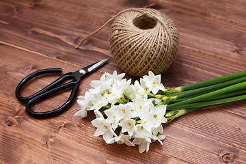 Image showing Florist scissors with white narcissi and ball of twine