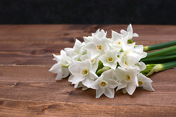 Image showing Freshly cut bunch of white narcissi on a wooden table