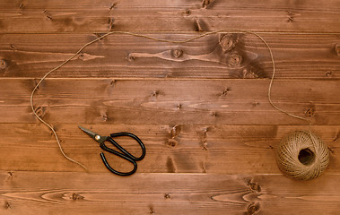 Image showing Ball of twine unwound across a wooden background