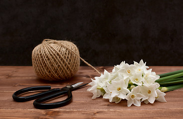 Image showing Ball of twine with scissors and white narcissi blooms