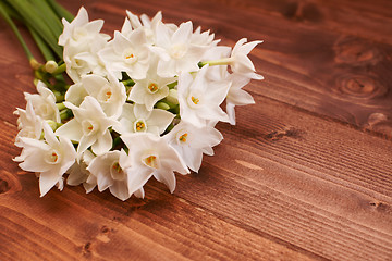 Image showing Fresh bouquet of white narcissus flowers on a wooden table