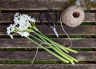 Image showing Ball of twine and scissors with bunch of white narcissi