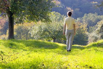 Image showing Woman walking in a autumn landscape