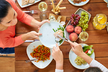 Image showing women eating chicken for dinner