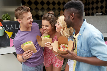 Image showing happy friends with wok and burger at food truck