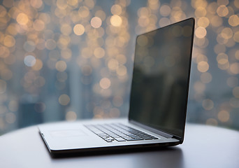 Image showing laptop and coffee cup on table at christmas