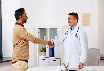 Image showing doctor and male patient shaking hands at hospital