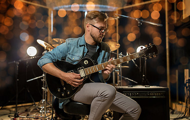 Image showing man playing guitar at studio rehearsal