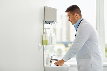 Image showing doctor washing hands at medical clinic sink